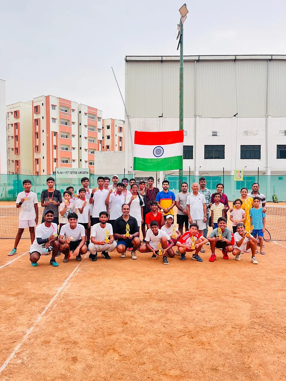 A large PLAY n FIT squad gathered on court beneath the Indian flag