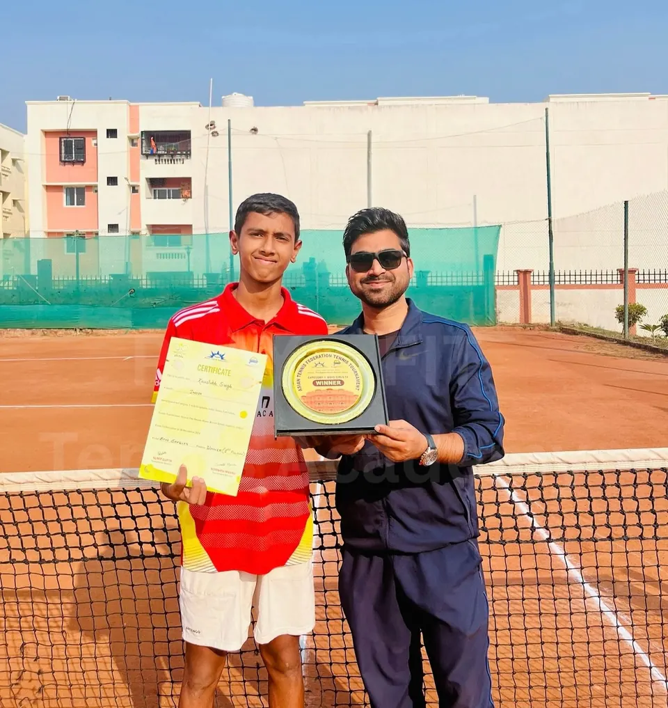 PLAY n FIT player holding a certificate and plaque beside his coach
