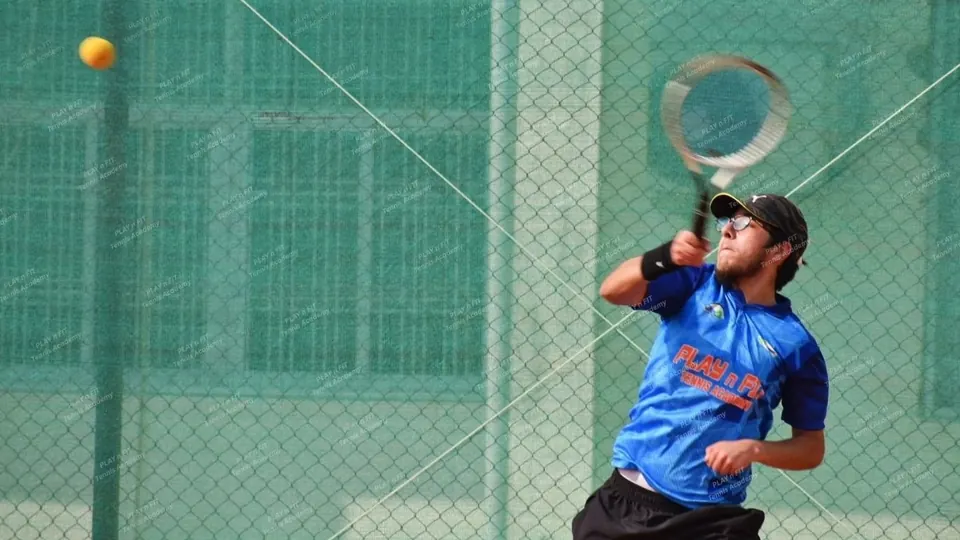 Player reaching up for an overhead shot