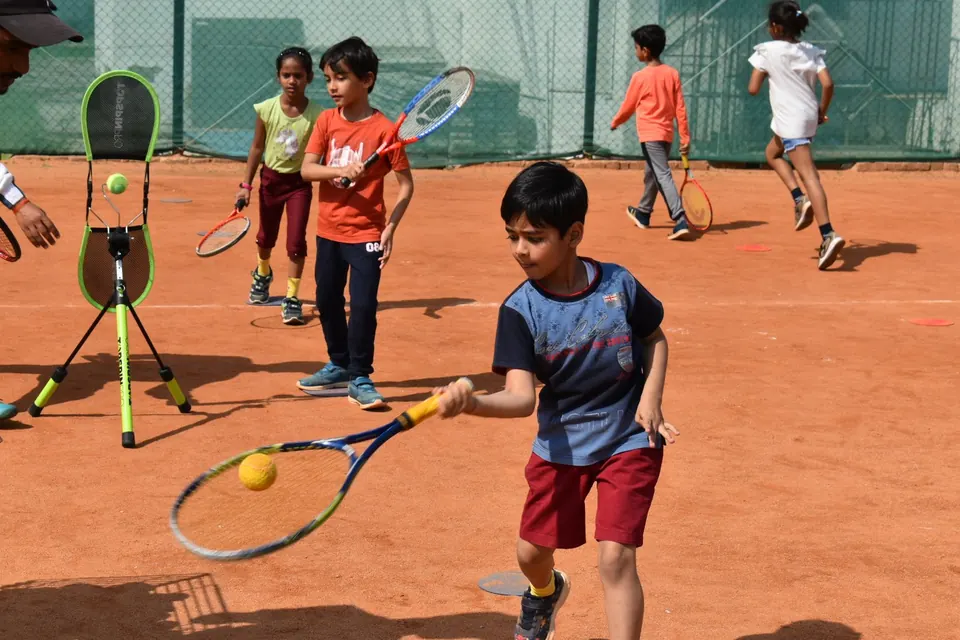 Children taking turns in a hitting drill