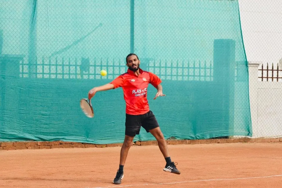 Adult player hitting a forehand on a clay court